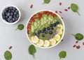 Healthy breakfast smoothie bowl topped with blueberry, kiwi, banana, spinach, Chia seeds and Goji berries. Detox concept. Royalty Free Stock Photo