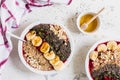 Healthy breakfast. Smoothie bowls with blueberries, banana, oat flakes, chia seeds, quinoa, pumpkin seeds and honey Royalty Free Stock Photo