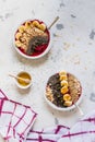 Healthy breakfast. Smoothie bowls with blueberries, banana, oat flakes, chia seeds, quinoa, pumpkin seeds and honey. Top view Royalty Free Stock Photo