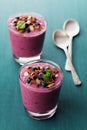 Healthy breakfast of smoothie, dessert, yogurt or milkshake with frozen blueberry and oats decorated grated chocolate and mint Royalty Free Stock Photo