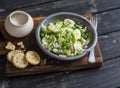 Healthy breakfast or snack - salad with cucumber, celery, quail eggs and cheese and homemade savoury cheese biscuits on a wooden r Royalty Free Stock Photo