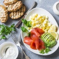 Healthy breakfast or snack - smoked salmon, scramble egg and avocado. On a gray background, top view. Healthy food Royalty Free Stock Photo