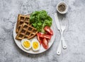 Healthy breakfast, snack - zucchini waffles, boiled egg, fresh tomatoes, lettuce on a gray background, top view
