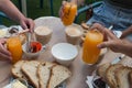 Healthy breakfast with some friends: fresh orange juice, coffee, delicious traditional bread , butter and confiture. Portugal