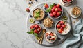 Healthy breakfast spread with granola, berries, and yogurt on marble table Royalty Free Stock Photo