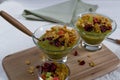 Healthy breakfast, summer dessert with smoothie kiwi, corn flakes and dried fruits in a glassware Royalty Free Stock Photo