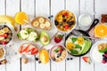 Healthy breakfast table scene with fruits, yogurts, oatmeal, cereal, smoothie bowl, nutritious toasts and egg skillet, top view ov Royalty Free Stock Photo