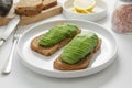 Healthy breakfast toast with avocado slices on white background Royalty Free Stock Photo