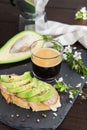 Healthy breakfast. Toasted grain bread with fresh sliced avocado, ham, cheese and cup of coffee Royalty Free Stock Photo