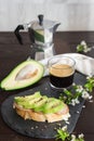 Healthy breakfast. Toasted grain bread with fresh sliced avocado, ham, cheese and cup of coffee Royalty Free Stock Photo