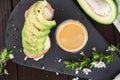 Healthy breakfast. Toasted grain bread with fresh sliced avocado, ham, cheese and cup of coffee Royalty Free Stock Photo