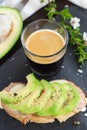 Healthy breakfast. Toasted grain bread with fresh sliced avocado, ham, cheese and cup of coffee Royalty Free Stock Photo