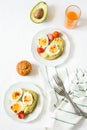 Healthy breakfast: toasts with avocado slices, tomato, paprika and eggs Royalty Free Stock Photo