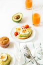 Healthy breakfast: toasts with avocado slices, tomato, paprika and eggs Royalty Free Stock Photo