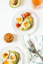 Healthy breakfast: toasts with avocado slices, tomato, paprika and eggs