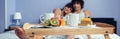 Healthy breakfast on tray and couple lying in background Royalty Free Stock Photo