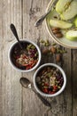 Healthy breakfast.Two bowls of muesli with oats, nuts and dried fruits - apples, resins, pumpkin seeds and almonds on wooden table