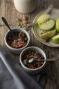 Healthy breakfast.Two bowls of muesli with oats, nuts and dried fruits - apples, resins, pumpkin seeds and almonds on wooden table