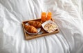 Healthy breakfast for two with orange juice, croissants and granola bed, above view. Romantic meal for lovers concept Royalty Free Stock Photo