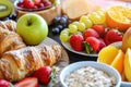 Healthy breakfast. Vibrant photo of table full of fresh fruit, oatmeal and healthy croissants. Balanced diet. Royalty Free Stock Photo