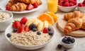 Healthy breakfast. Vibrant photo of table full of fresh fruit, oatmeal and healthy croissants. Balanced diet. Royalty Free Stock Photo