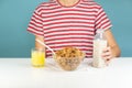 Healthy breakfast with whole grain cereals, milk and juice. Illustrative minimalistic image of vegetarian food on the table and h