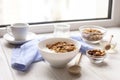 Healthy breakfast on window sill homemade granola with nuts Royalty Free Stock Photo