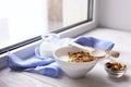 Healthy breakfast on window sill homemade granola with nuts Royalty Free Stock Photo