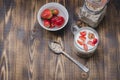 Healthy breakfast. Yogurt, fresh strawberry, homemade granola in open glass jar on a wooden table. Top view and copyspace Royalty Free Stock Photo