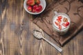 Healthy breakfast. Yogurt, fresh strawberry, homemade granola in open glass jar on a wooden table. Top view, copyspace Royalty Free Stock Photo