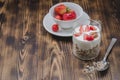 Healthy breakfast. Yogurt, fresh strawberry,  spoon with the scattered granule on a wooden table. Copyspace Royalty Free Stock Photo