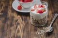 Healthy breakfast. Yogurt, fresh strawberry,  spoon with the scattered granule on a wooden table. Copyspace Royalty Free Stock Photo