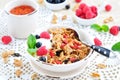 Healthy breakfast, yogurt with granola and berries on the white table Royalty Free Stock Photo