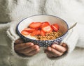 Healthy breakfast yogurt, granola, strawberry bowl in hands of woman Royalty Free Stock Photo