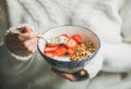 Healthy breakfast yogurt, granola, strawberry bowl in woman`s hands Royalty Free Stock Photo