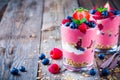 Healthy breakfast: yogurt parfait with granola and raspberry, blueberry and strawberry on wooden table Royalty Free Stock Photo