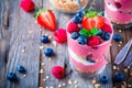 Healthy breakfast: yogurt parfait with granola and raspberry, blueberry and strawberry on wooden table Royalty Free Stock Photo