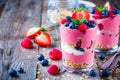 Healthy breakfast: yogurt parfait with granola and raspberry, blueberry and strawberry on wooden table Royalty Free Stock Photo