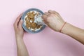 Healthy breakfast. A young woman is pouring cereals with milk.pink background. top veiw Royalty Free Stock Photo