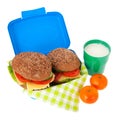 Healthy brown bread roll in blue lunch box with fruit and milk Royalty Free Stock Photo