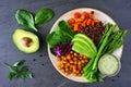 Healthy Buddha bowl with asparagus, quinoa, sweet potato, chickpeas and avocado, top view over slate Royalty Free Stock Photo