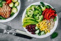 Healthy buddha bowl salad with grilled vegetables. Quinoa, spinach, avocado, beans, sweet corn, broccoli, cucumbers and paprika Royalty Free Stock Photo
