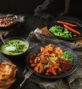 Healthy Buddha bowl salad with salmon, red quinoa, baked vegetables, micro greens and cream soup with green beans in bowl on dark Royalty Free Stock Photo