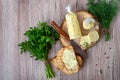 Healthy butter with dill, parsley in the form of a roll, slices for easy use. Herbal butter on a cutting board for toasted,