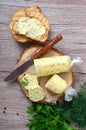 Healthy butter with dill, parsley in the form of a roll, slices for easy use. Herbal butter on a cutting board for toasted,