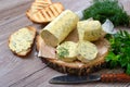 Healthy butter with dill, parsley in the form of a roll, slices for easy use. Herbal butter on a cutting board for toasted,