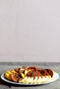 Healthy cacao pancakes with bananas, apples and caramel sauce on a white plate isolated on wooden background Royalty Free Stock Photo