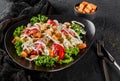 Healthy Caesar salad of fresh vegetables with tomatoes, lettuce, croutons, grilled chicken breast, cheese parmesan and sauce in Royalty Free Stock Photo