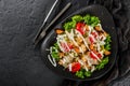 Healthy Caesar salad of fresh vegetables with tomatoes, lettuce, croutons, grilled chicken breast, cheese parmesan and sauce in Royalty Free Stock Photo