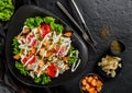 Healthy Caesar salad of fresh vegetables with tomatoes, lettuce, croutons, grilled chicken breast, cheese parmesan and sauce in Royalty Free Stock Photo